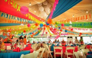 A vibrant wedding reception adorned with colorful decorations, creating a festive and joyous atmosphere.