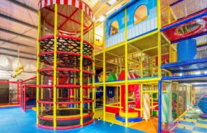 A vibrant play area with colorful slides and swings, providing endless fun and excitement for children.