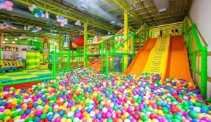 A vibrant indoor play area filled with colorful balls and exciting slides for children to enjoy.